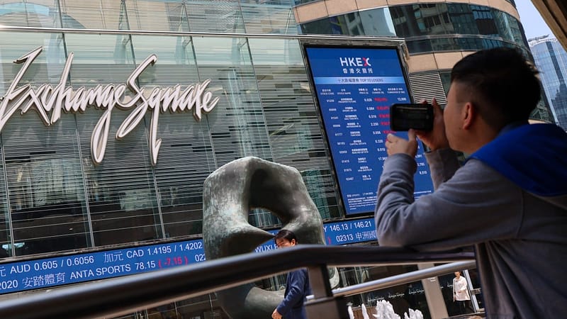 Hong Kong stocks waver as investors await details on policy support from Beijing