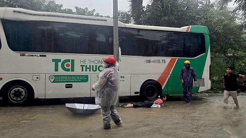 Hanoi residents suffer electric shocks while wading through flooded streets
